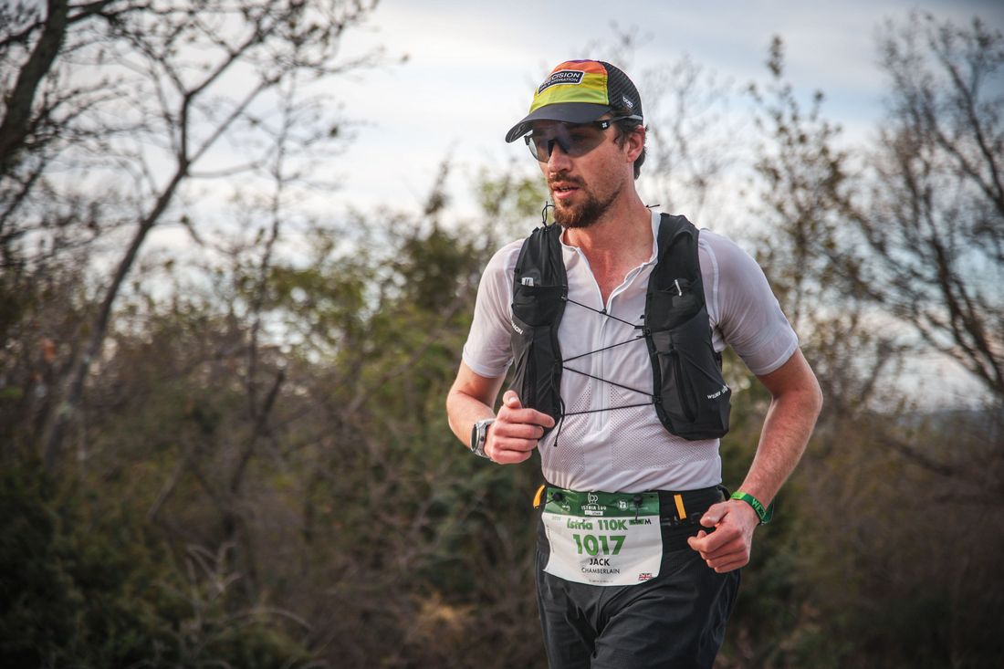 Jack Chamberlain running a gravel trail above the Istrian coast.
